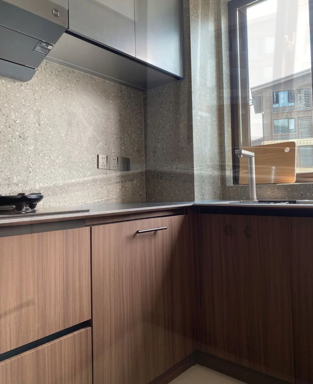Wood-tone cabinet and material reference beside a window