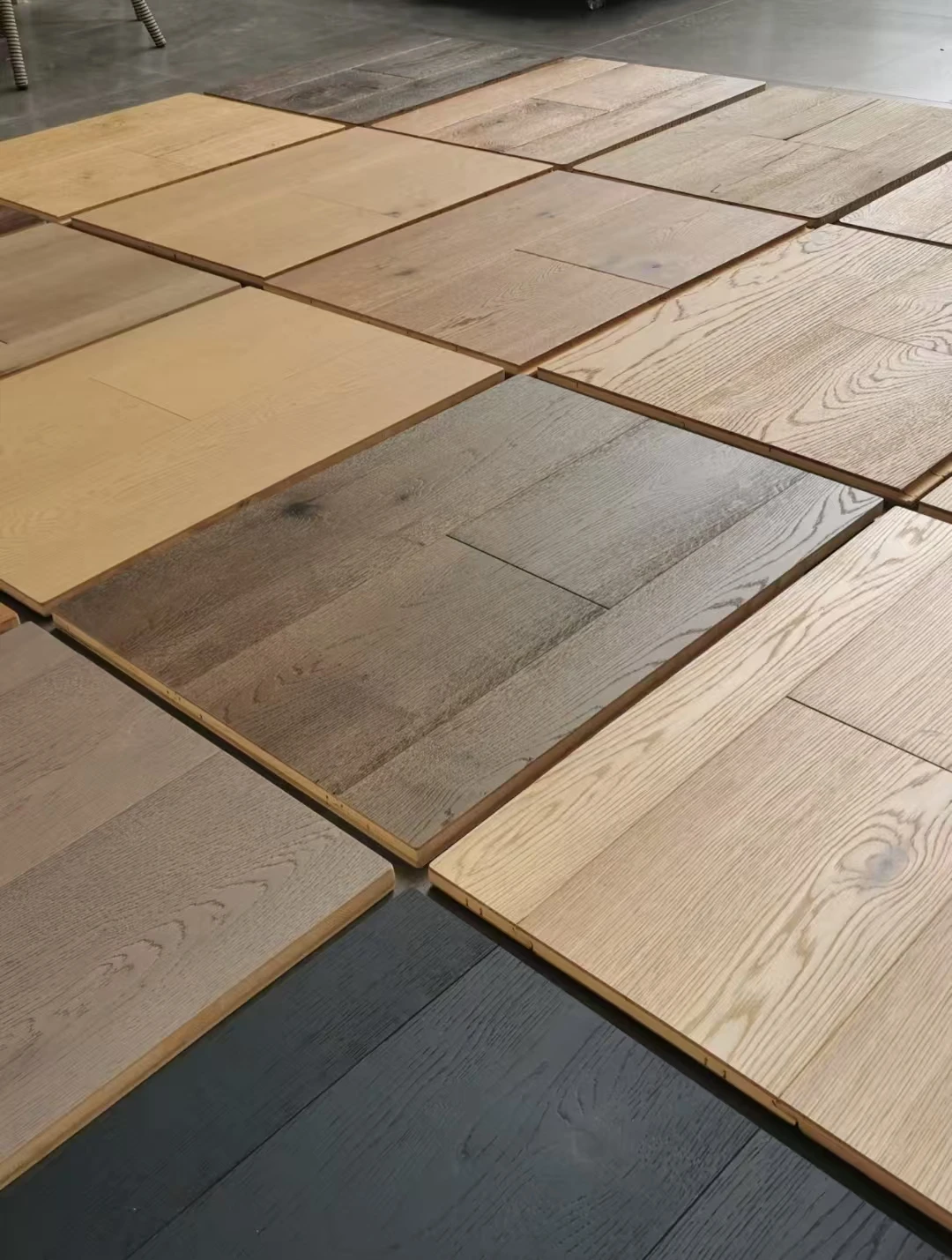 Flooring sample panels arranged to compare light, brown and grey wood-grain finishes