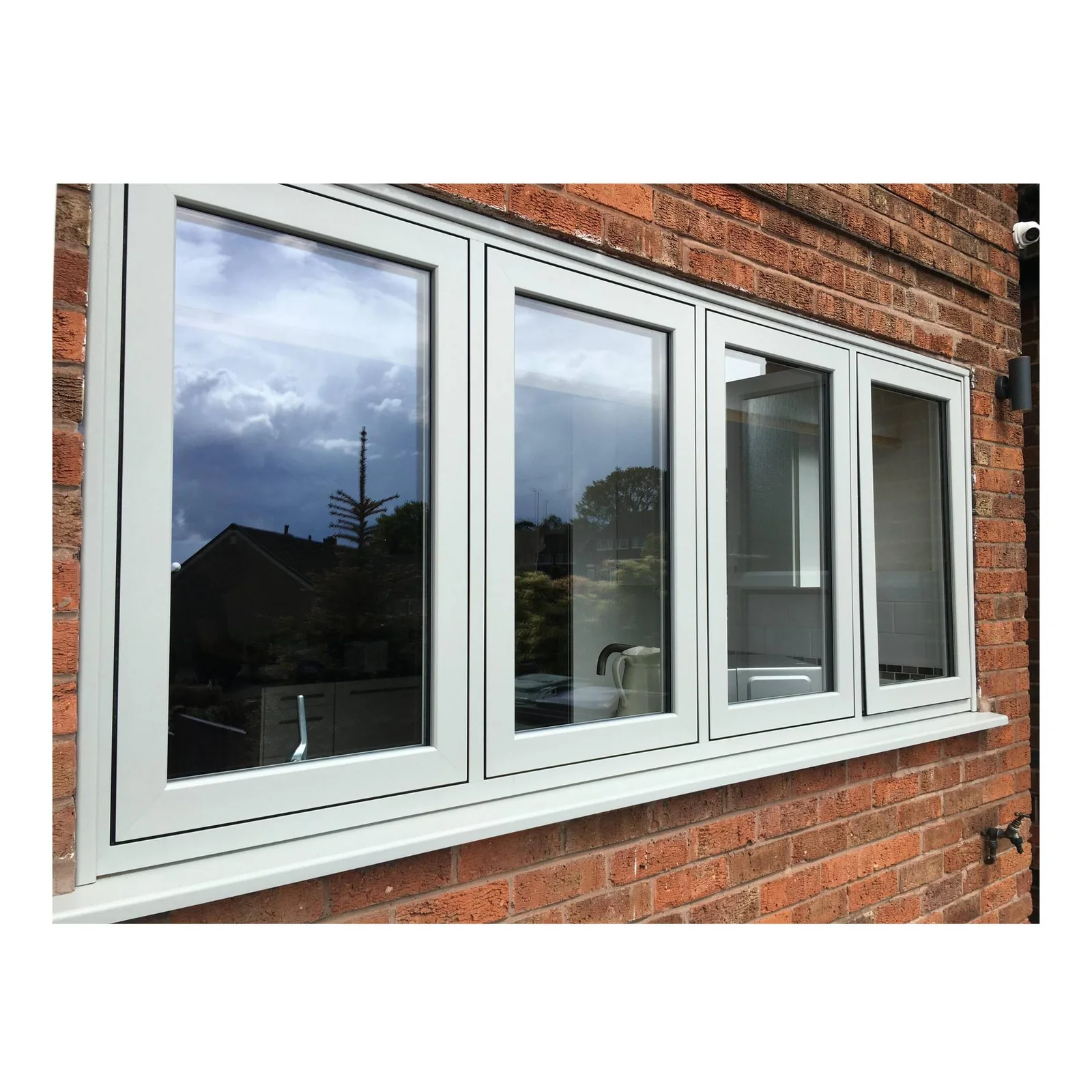White aluminum window system installed in a brick wall opening