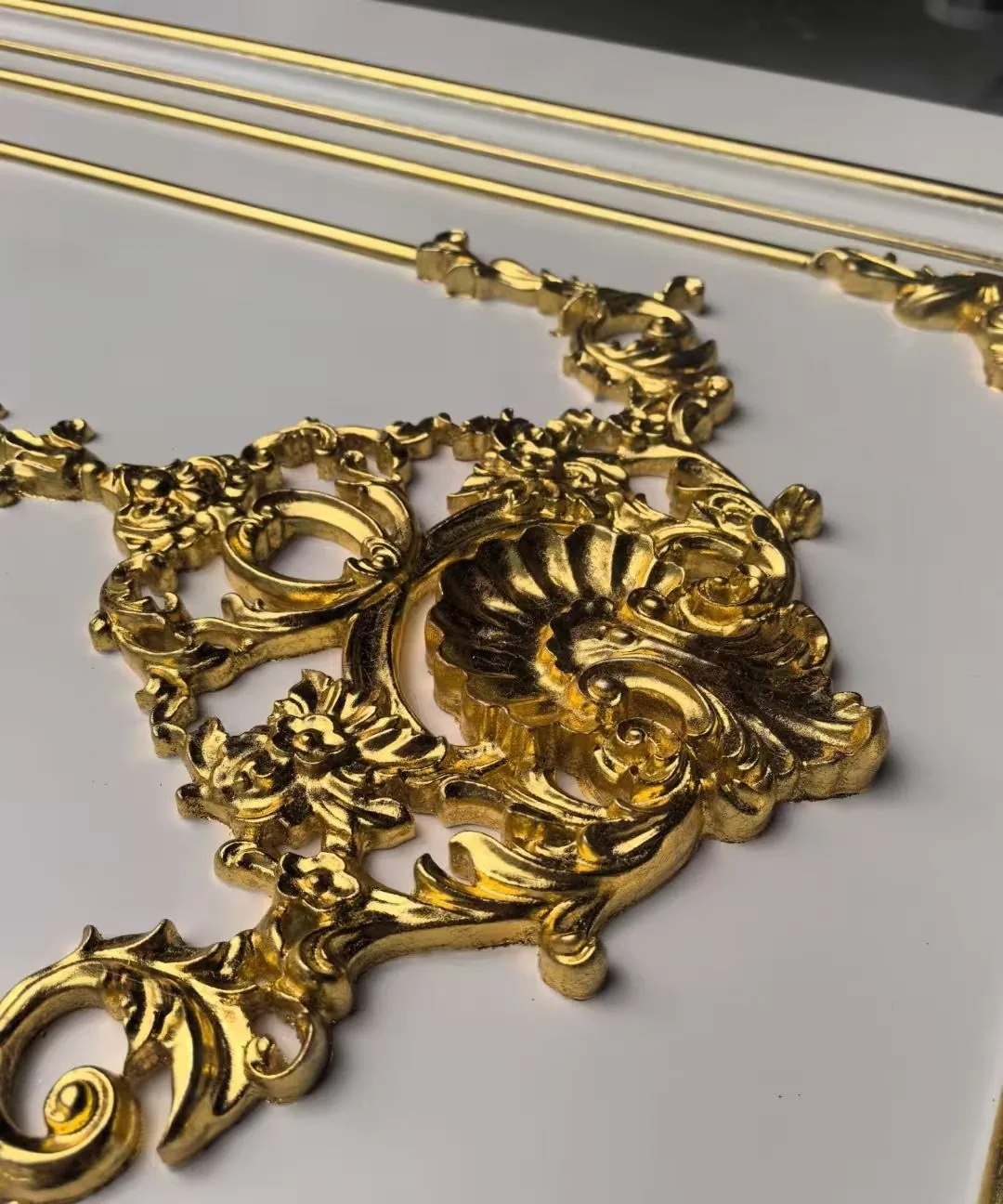 Gold-toned ornate moulding detail used as a decorative reference