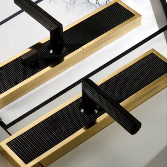 Black and gold-toned mechanical lever set with a linear backplate shown as a visible profile and finish reference
