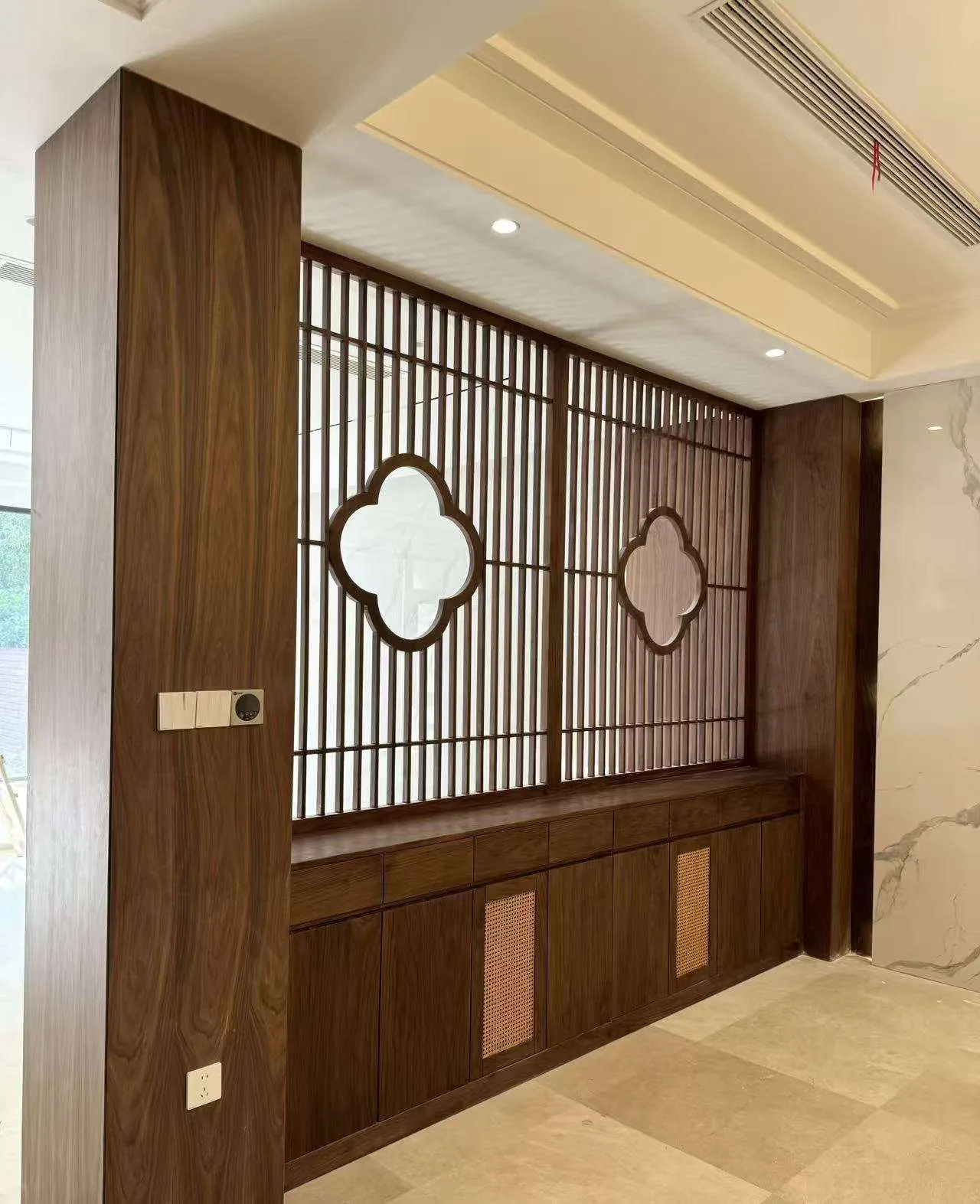 Wood lattice partition integrated with cabinetry used as a coordination reference