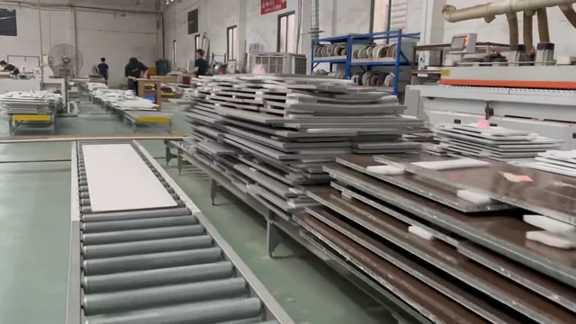 Stacks of panel components beside a workshop roller table